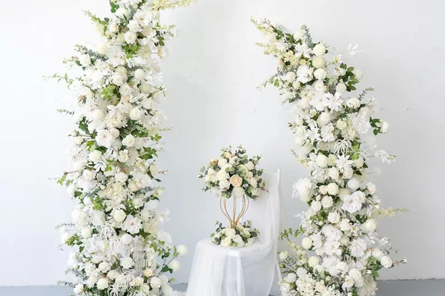 White floral pillars for wedding party.