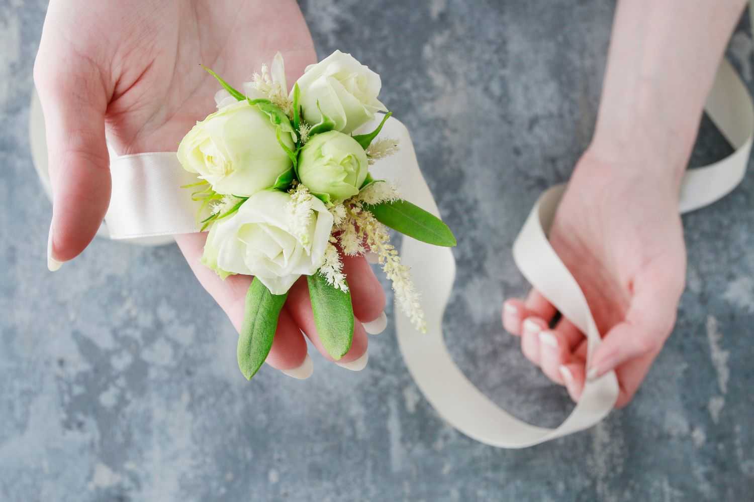 A girl placed a wrist flower in her hand Image from Pinterest