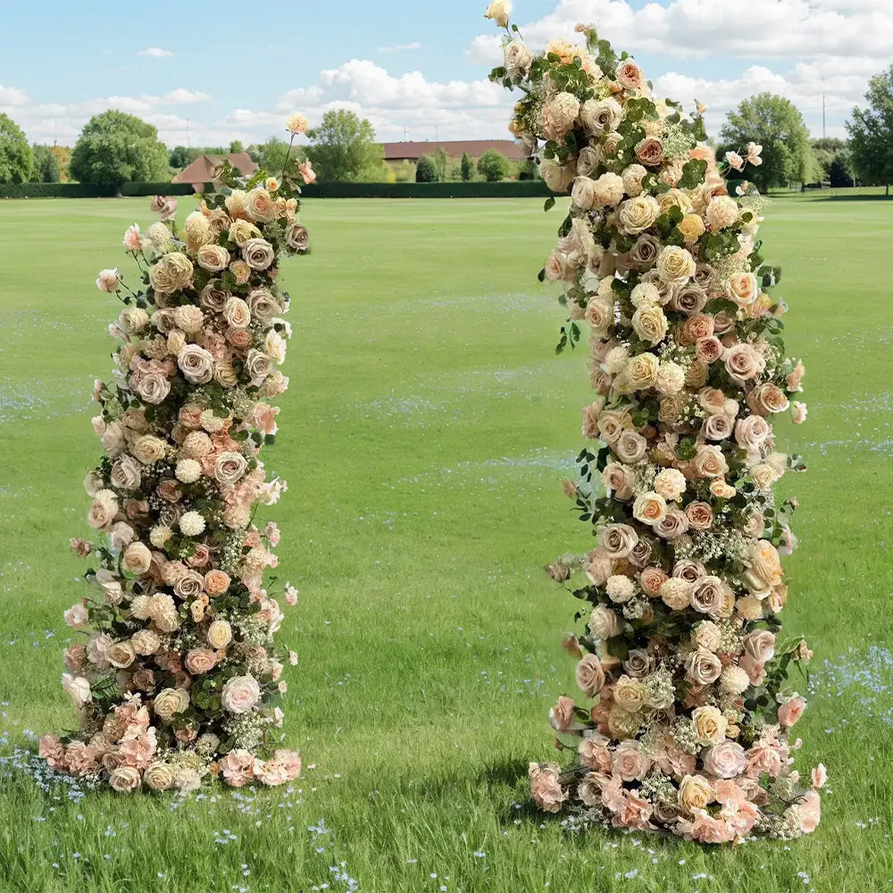 Elegant floral arch with champagne roses and greenery used for a wedding ceremony.