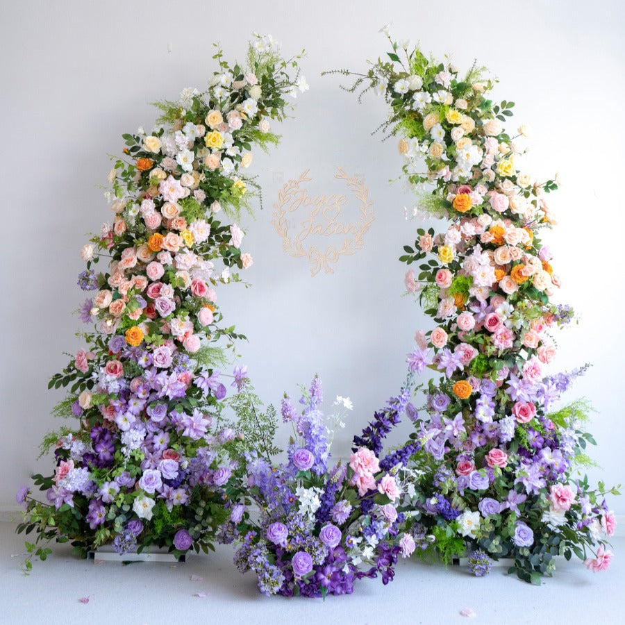 The purple green flower arch features a fabric backing, ensuring lifelike shapes and vibrant colors. 