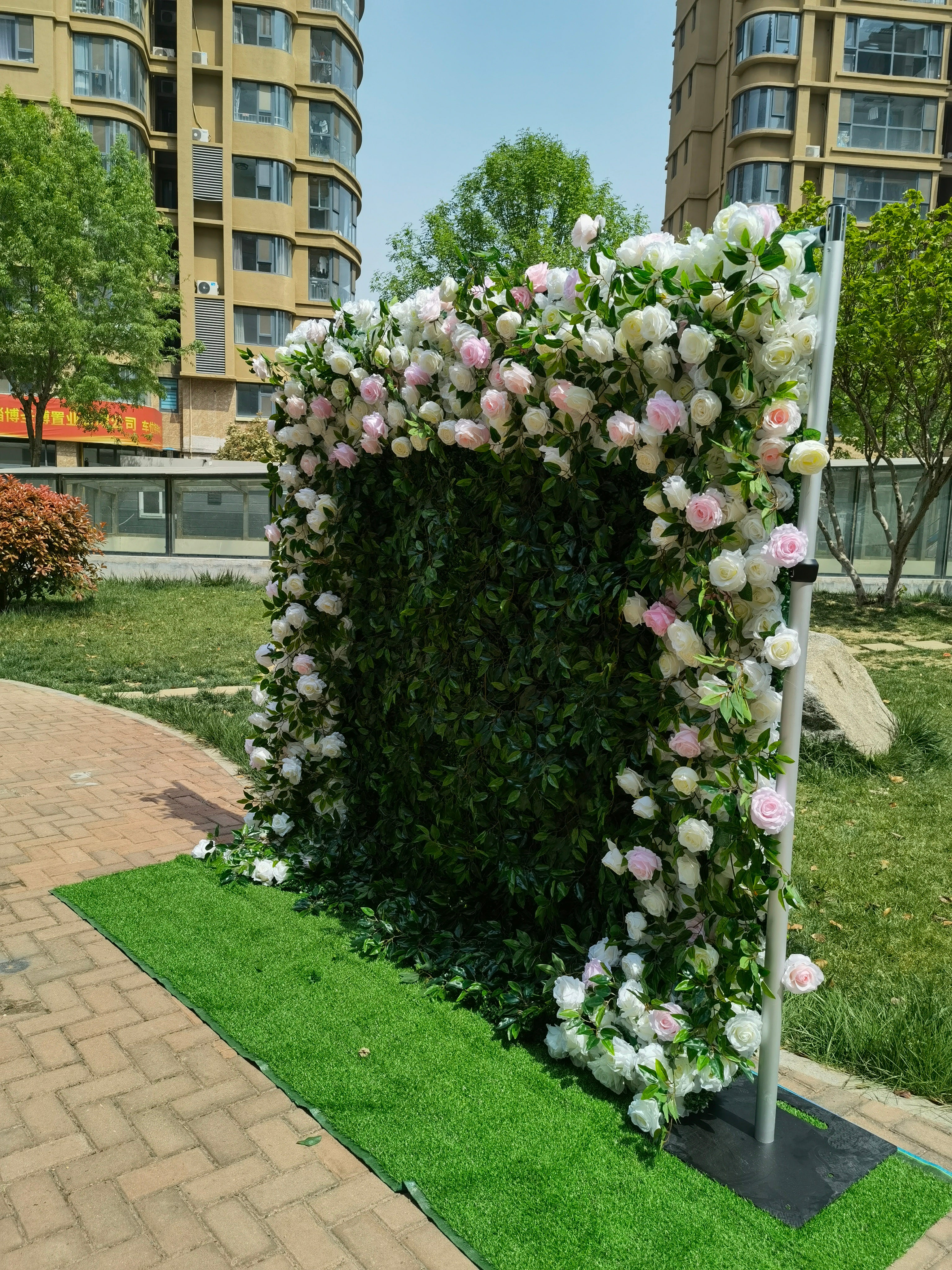 The pink white peony green leaves fabric flower wall looks full of life. 