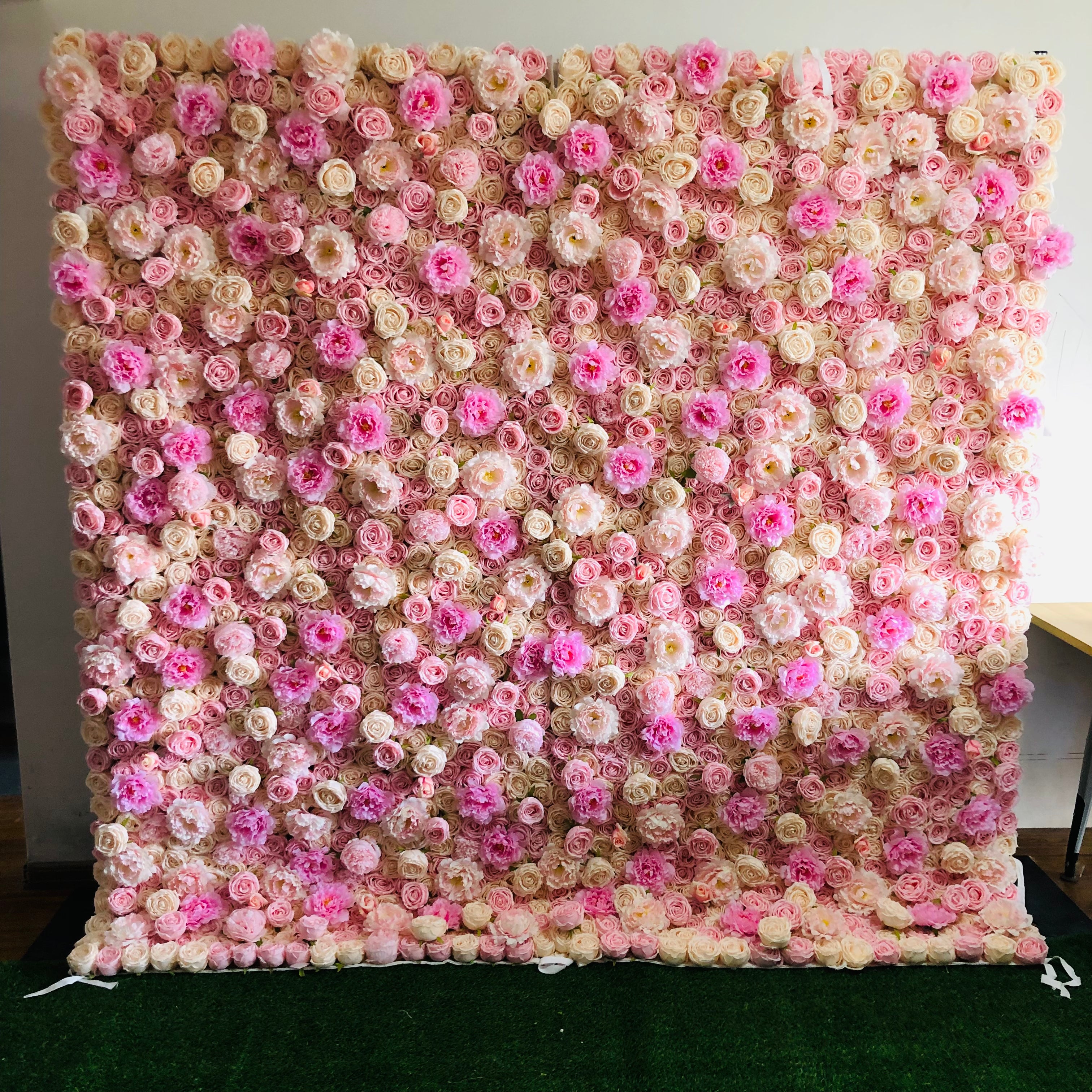 The pink champagne peony fabric flower wall looks cute and romantic.