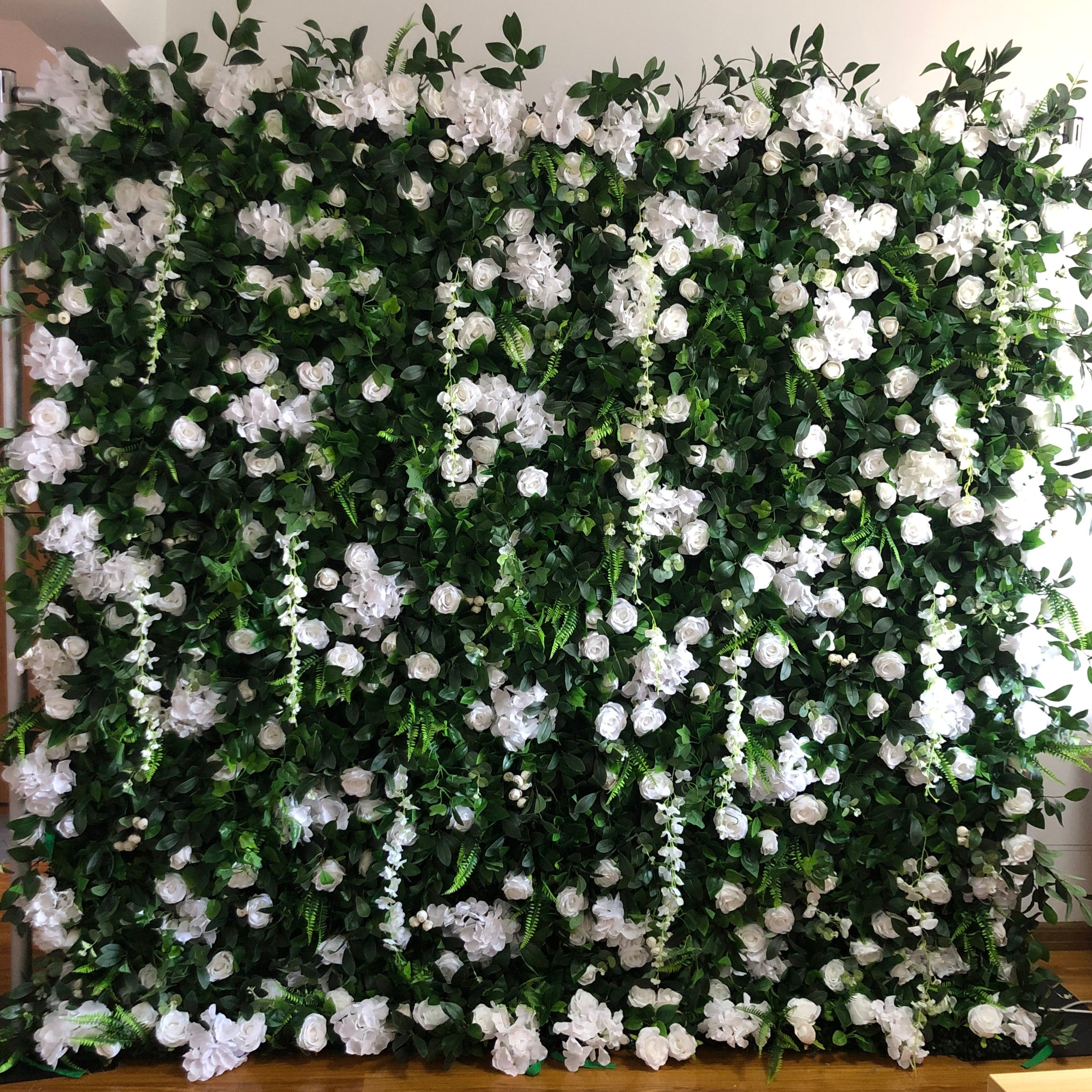 The green leaves and white rose fabric flower wall looks pure and beautiful.