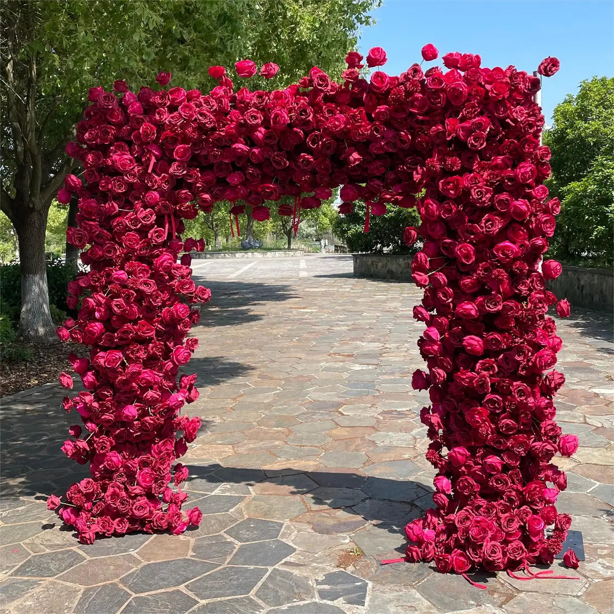 The wine red roses flower arch's side view boasts realistic shapes and a fabric backing.