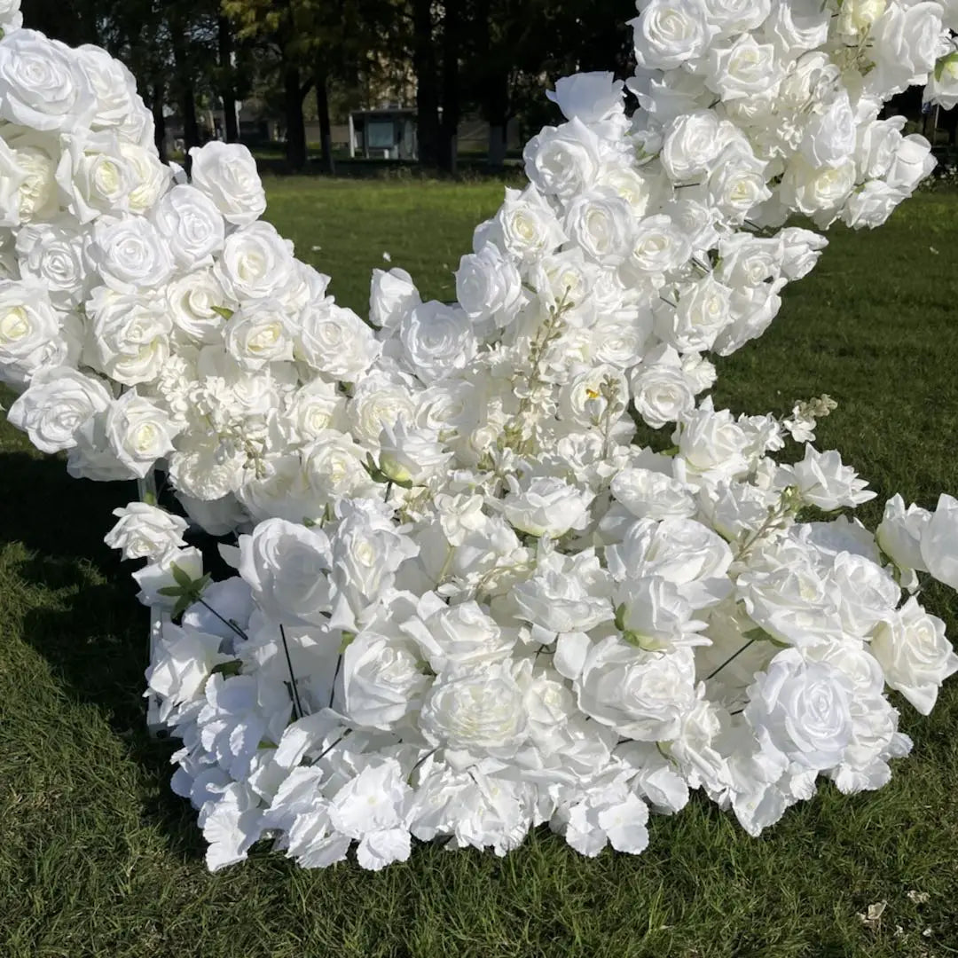 Artificial white roses for flower arch.