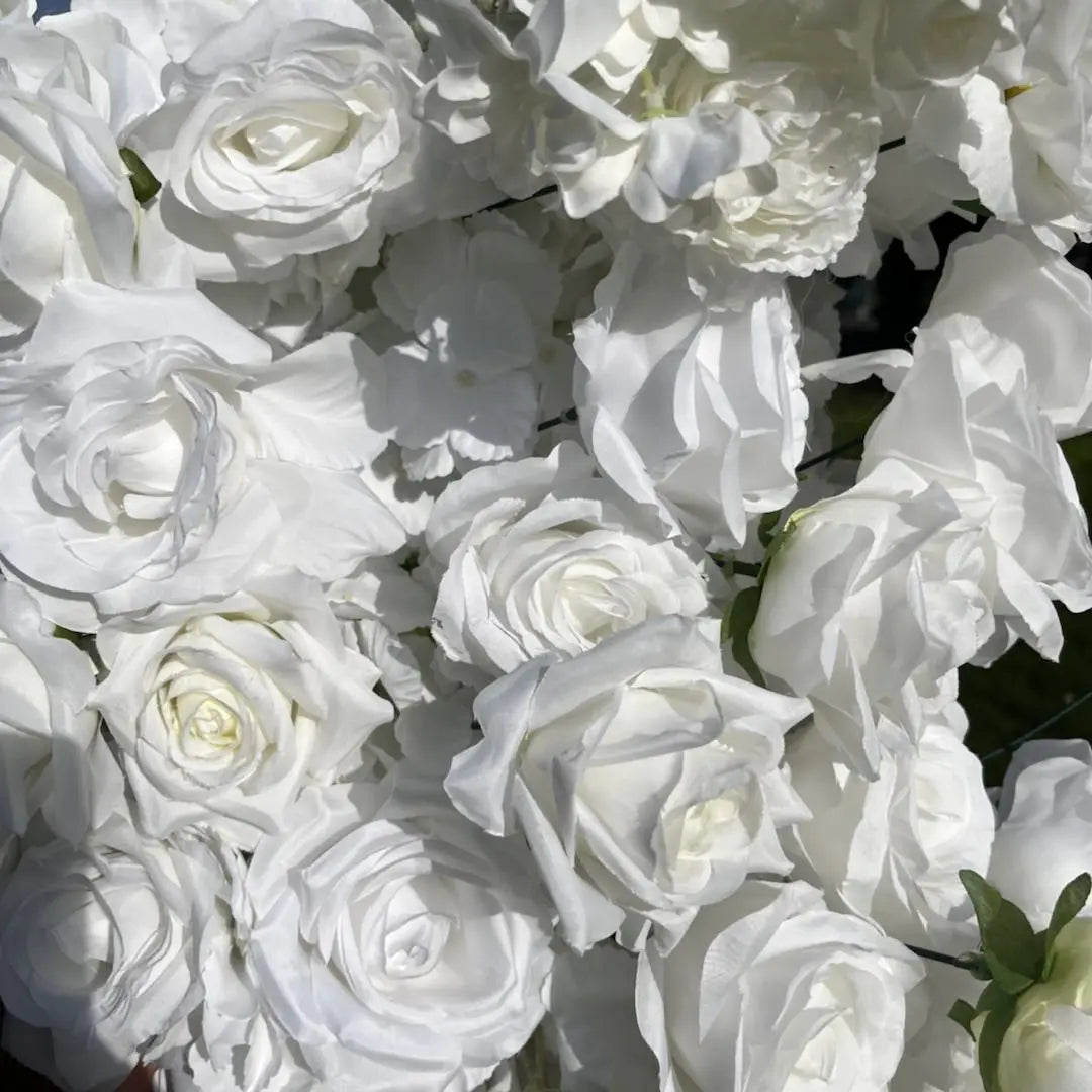 Artificial white roses for flower arch.