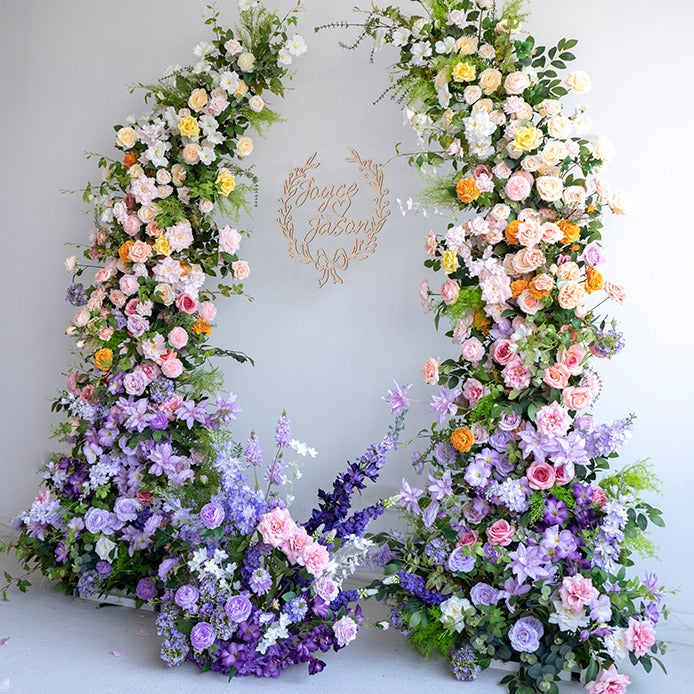 The purple green flower arch features a fabric backing, ensuring lifelike shapes and vibrant colors. 