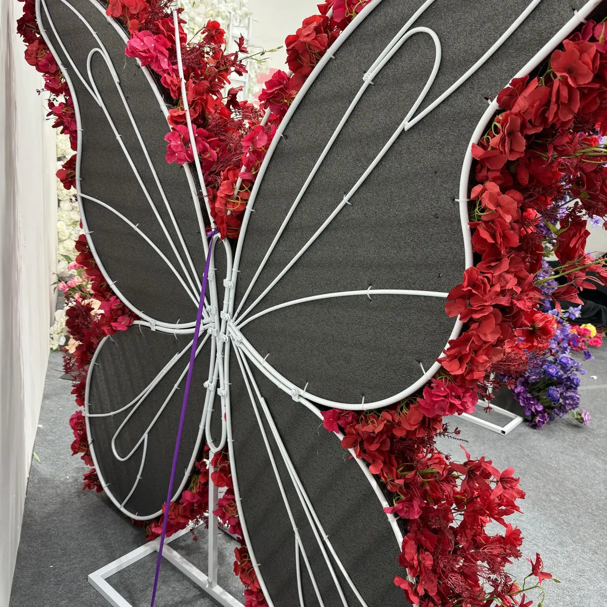 Butterfly red rose floral wall for wedding.