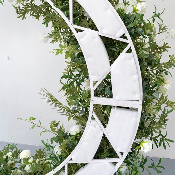 The backing of the green white moon flower arch.