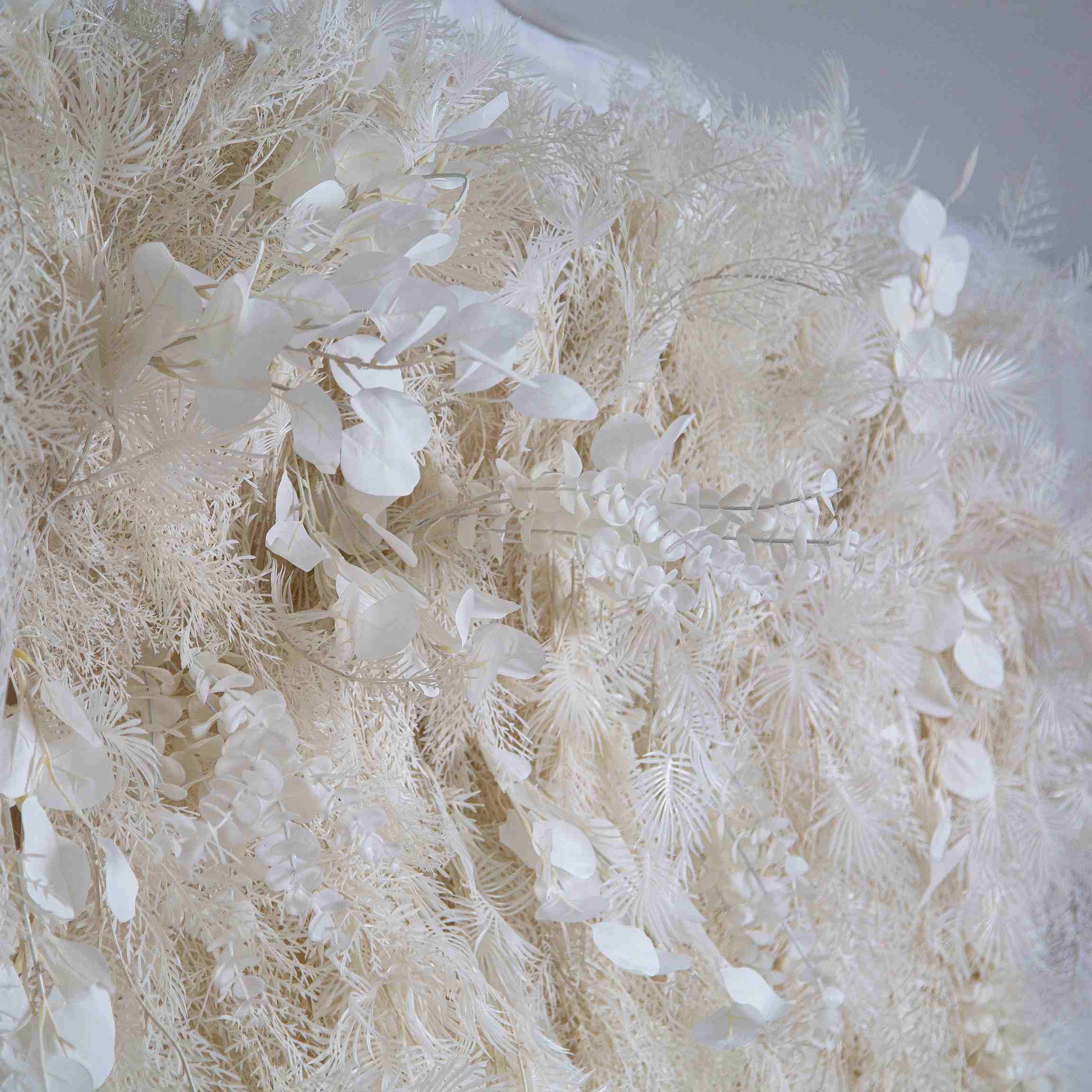 The white pampas fabric artificial flower wall looks vivid and realistic.