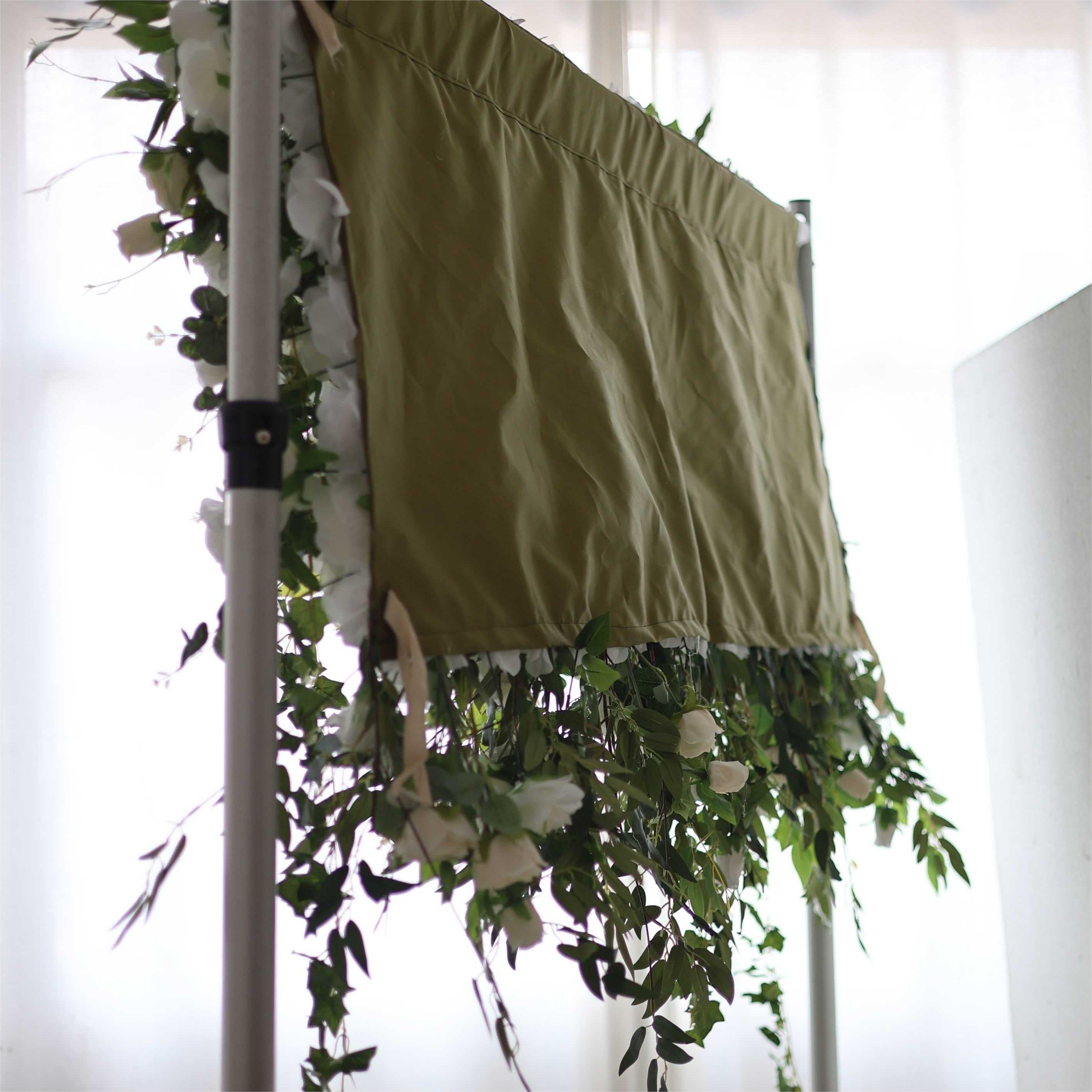 The white green florals flower wall is fixed to a cloth.