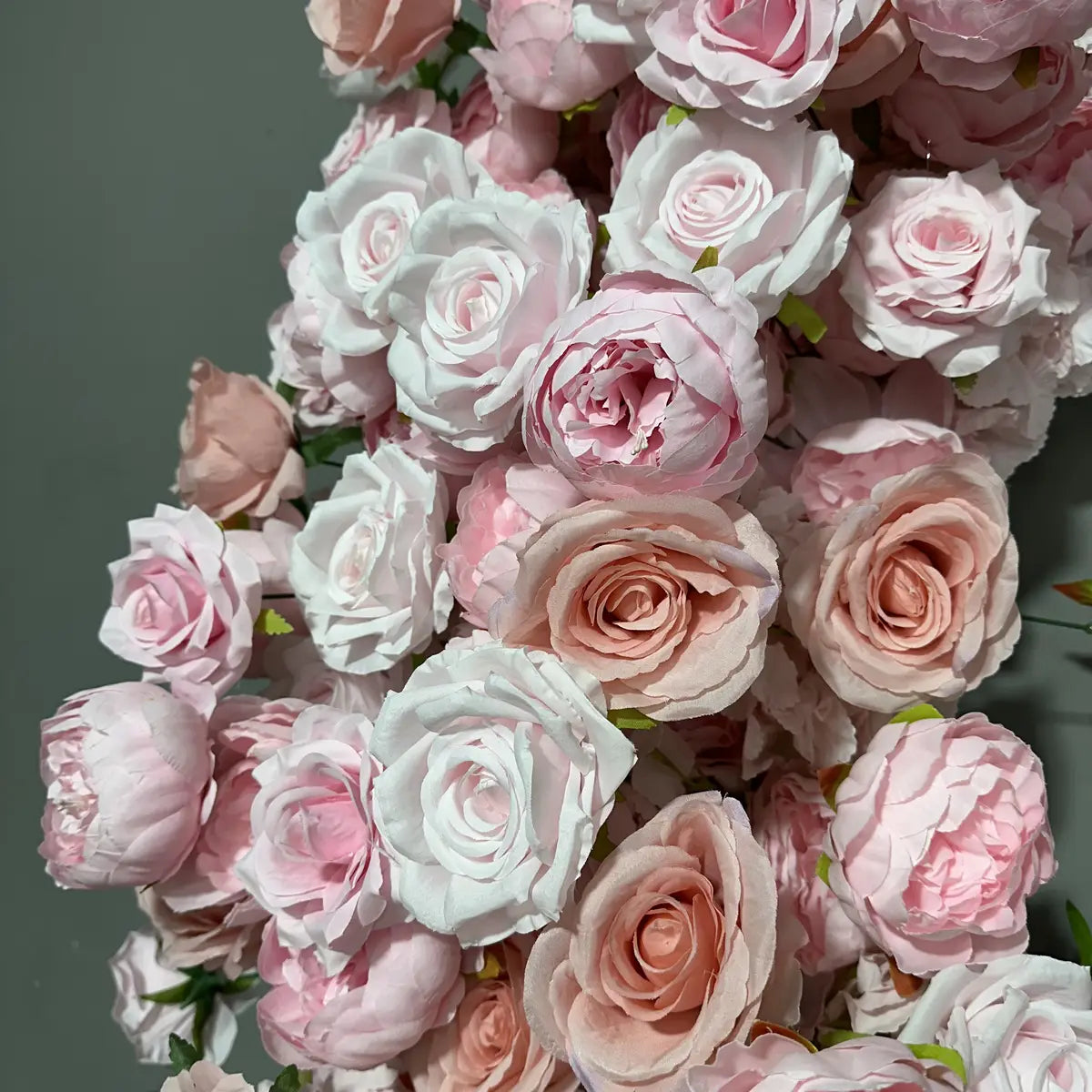 Pink artificial roses flower arch.