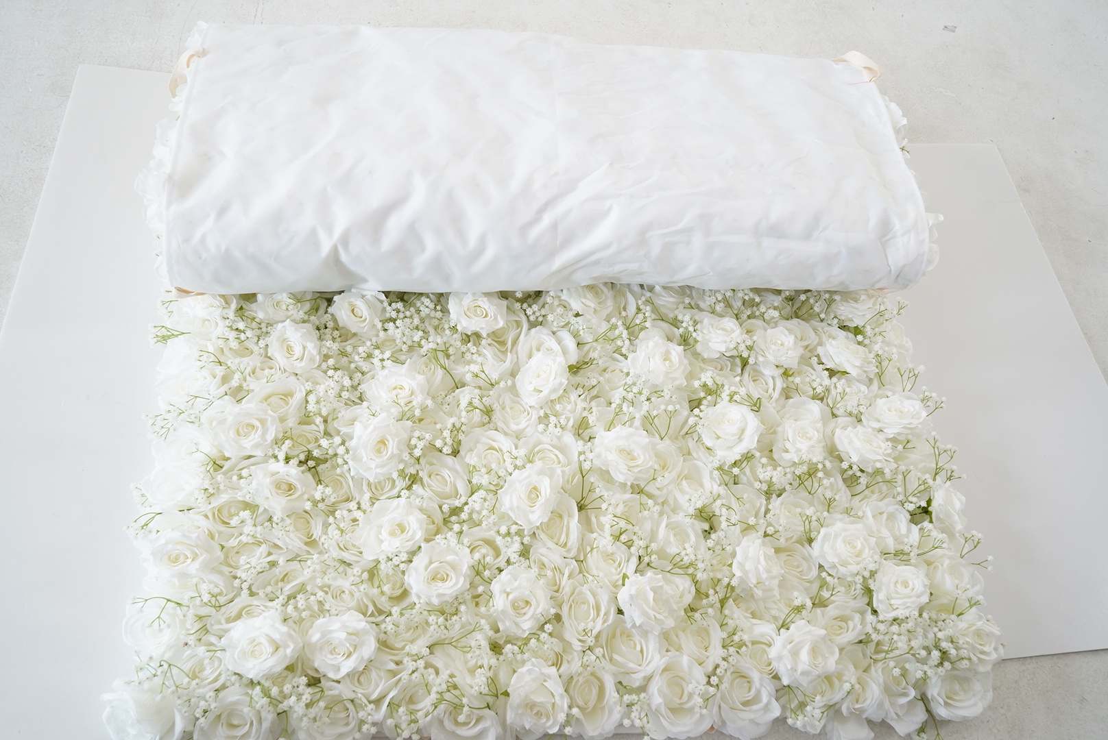 The baby breath pure white peony fabric flower wall looks vivid and lifelike.