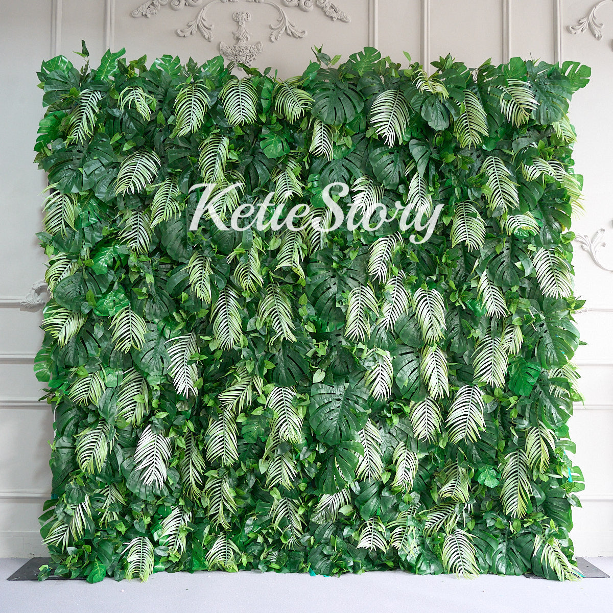 The rainforest fabric flower wall backdrop looks vibrant.