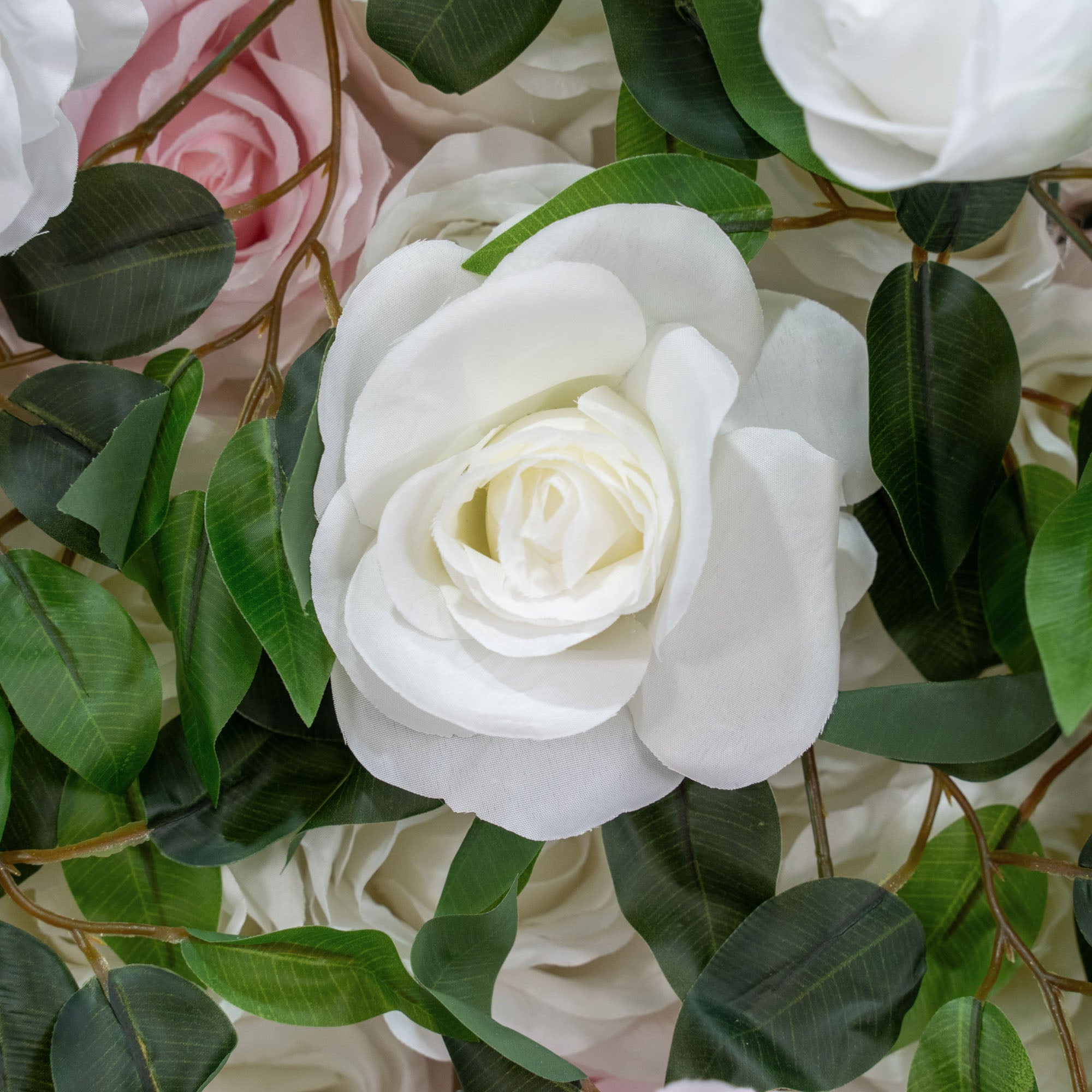 The green pink flower wall's detailed view highlights its vibrant, realistic shapes and fabric backing.