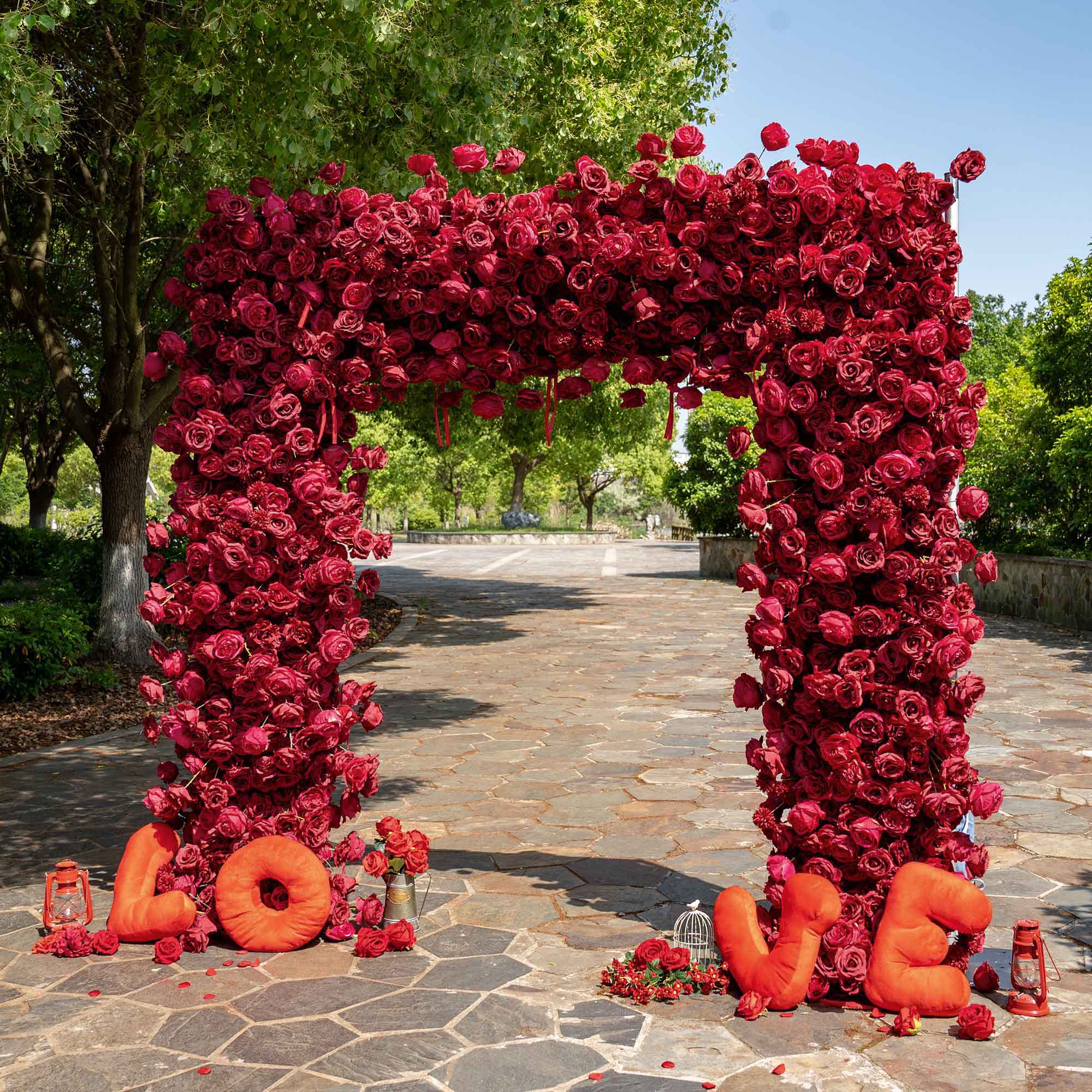 The wine red roses flower arch's side view boasts realistic shapes and a fabric backing.