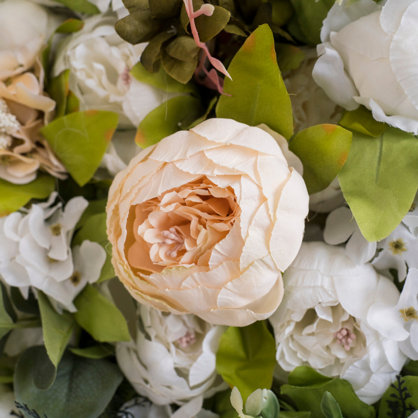 The white & light champagne peony flower wall's detailed view shows off vivid colors and a realistic fabric backing.