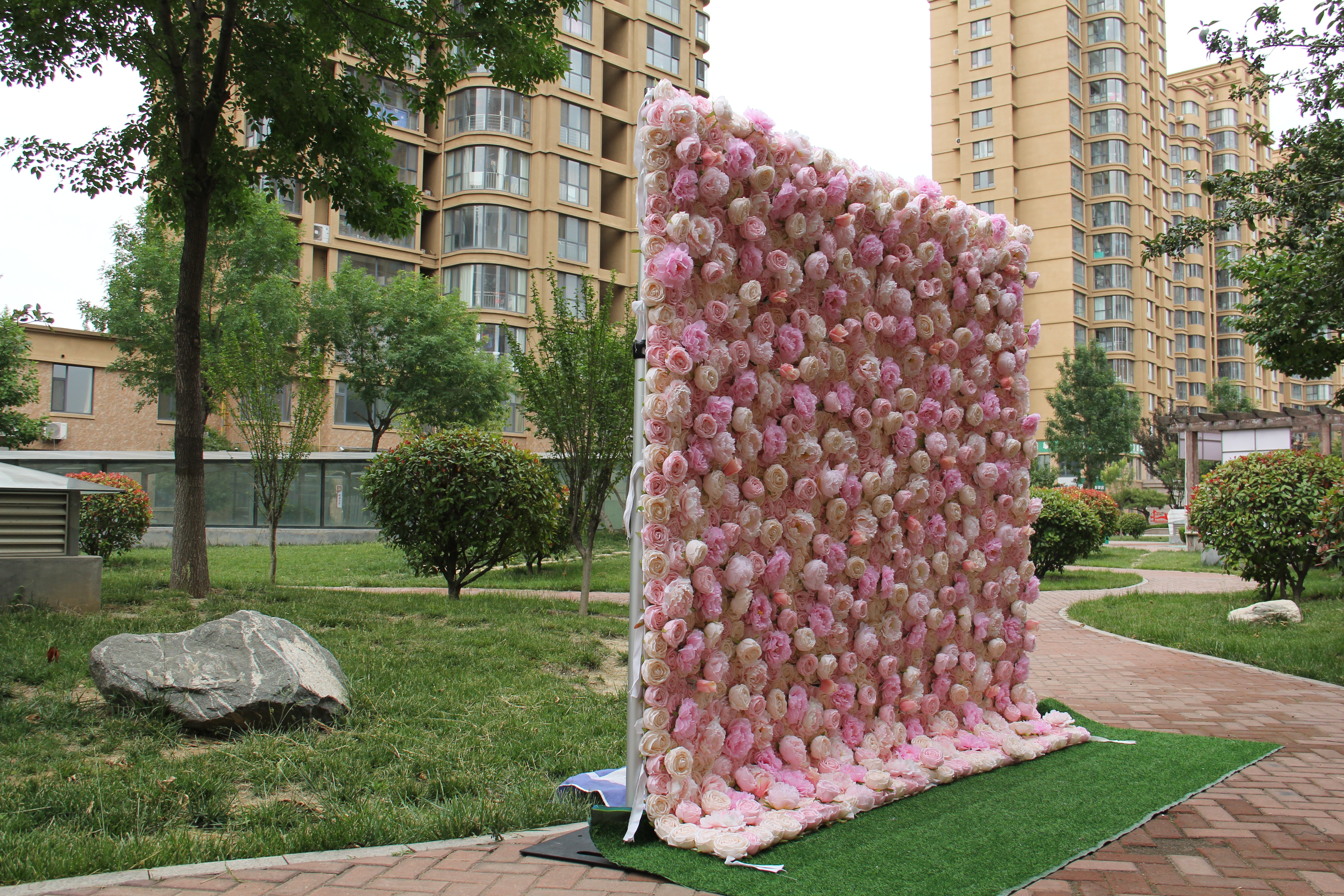 The pink champagne peony fabric flower wall looks cute and romantic.