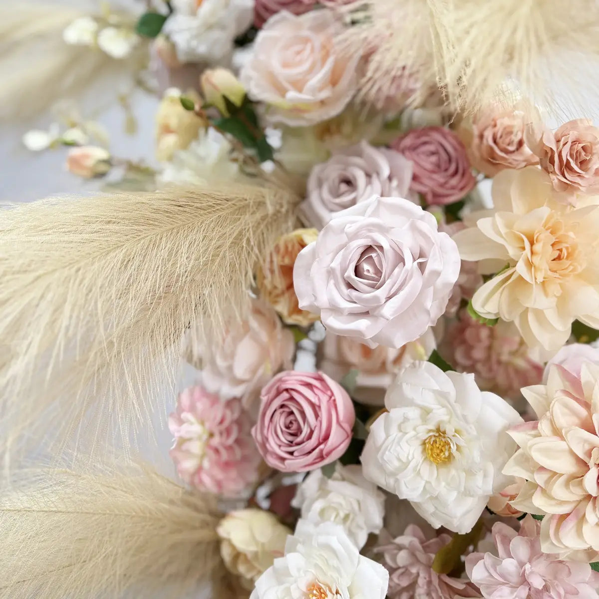 Artificial flower and feather on flower arch.