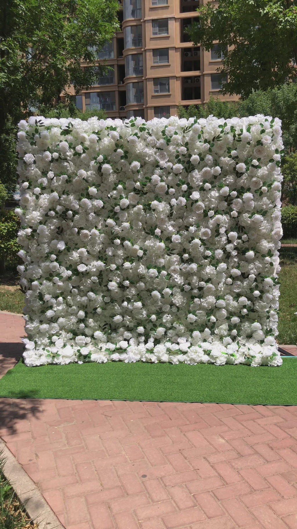 The white peony & green rose flower wall has a realistic look, is reusable, and is easy to install.