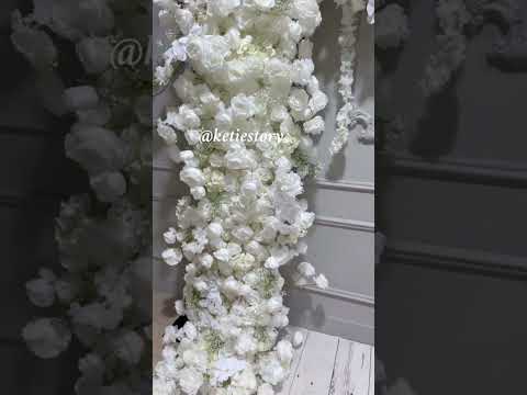 The white roses flower wall looks vivid and realistic.