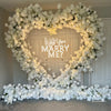 The white rose heart-shaped flower arch features a fabric backing, ensuring lifelike shapes and vibrant colors.